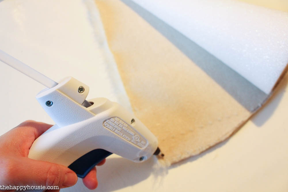 Using the hot glue gun to secure the edges.