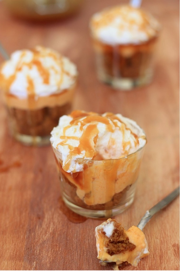Easy salted caramel pumpkin cream cheese parfait with a bite taken out of one individual cup.