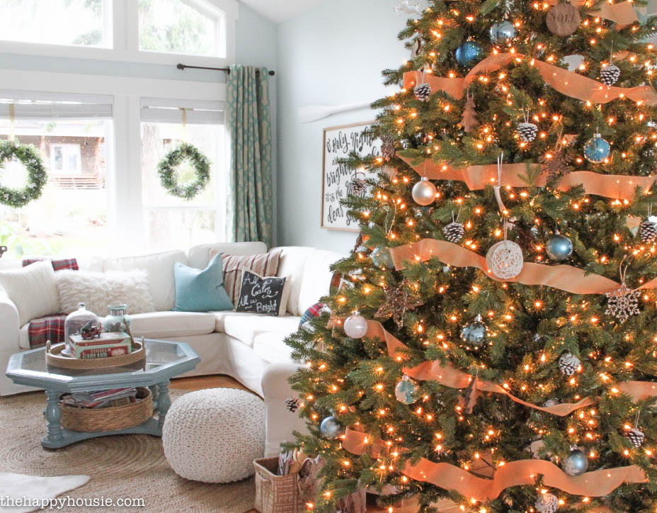Come tour this Christmas living room with lots of natural and rustic vintage touches as well as hits of red - coastal lake cottage Christmas at thehappyhousie.com-1