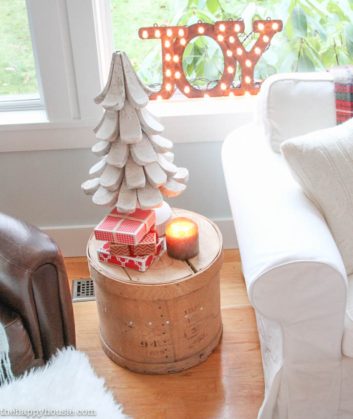 Come tour this Christmas living room with lots of natural and rustic vintage touches as well as hits of red - coastal lake cottage Christmas at thehappyhousie.com-13