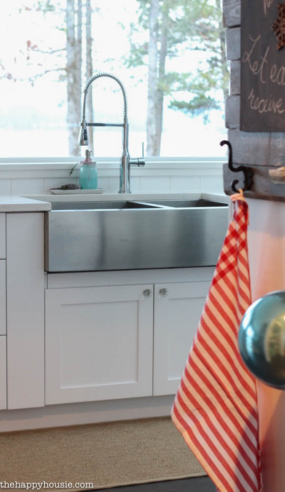 A stainless steel apron sink in the cottage house.