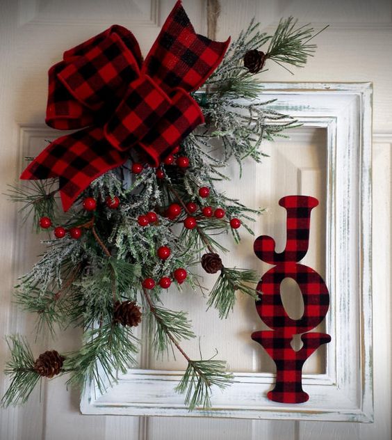 A flannel bow, and a flannel JOY sign with berries and evergreen.