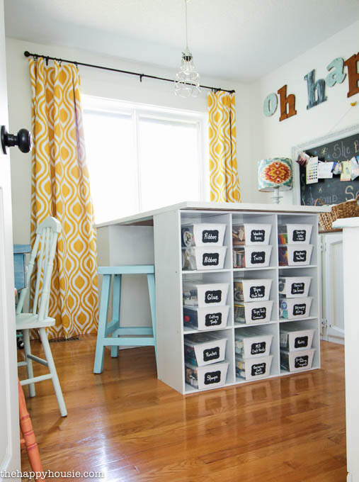 Colourful Cheery Craft Room Tour  with a shelf filled with craft boxes.