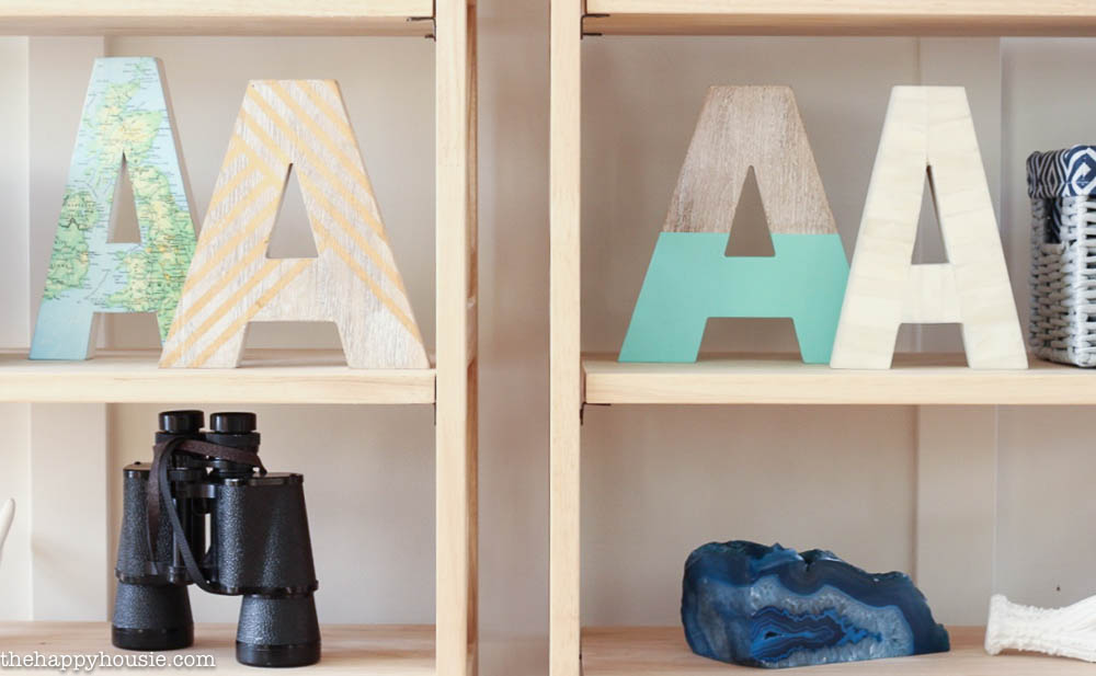 Letter A's are on the shelf beside binoculars.