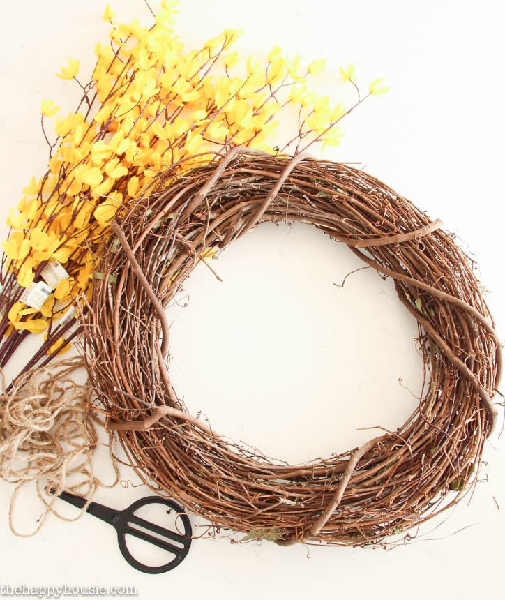 A wreath, and the forsythia flowers beside it.