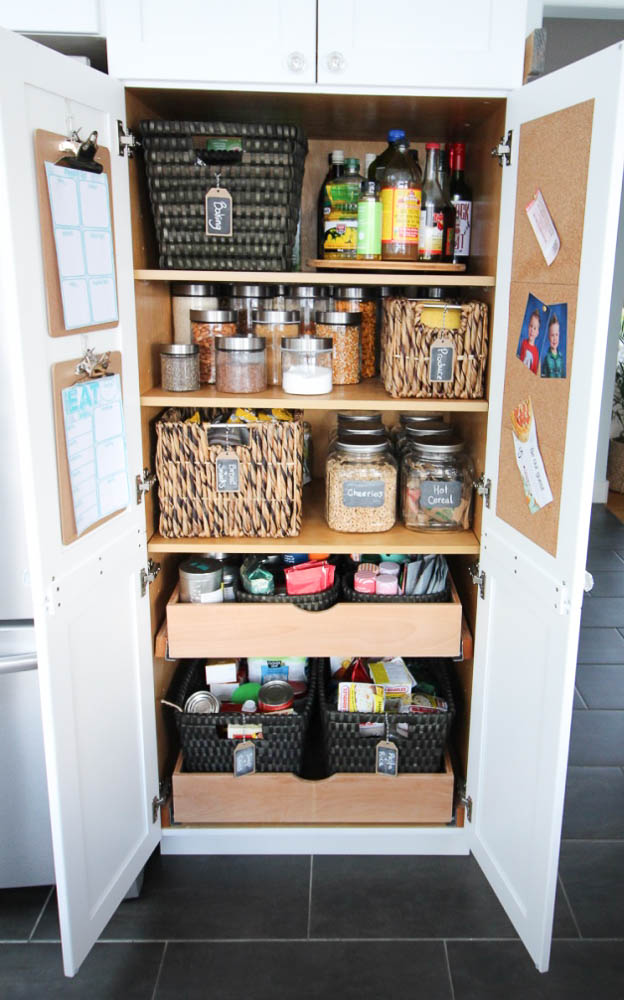 A picture of the organized pantry with the doors open.