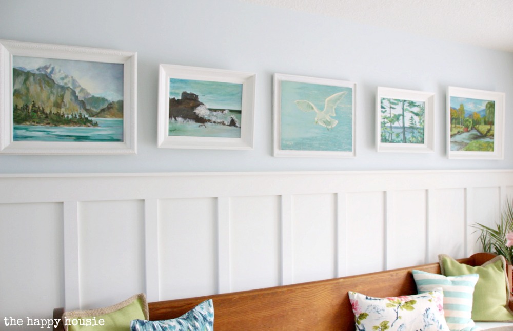 All the paintings on the wall in white frames in the dining room.