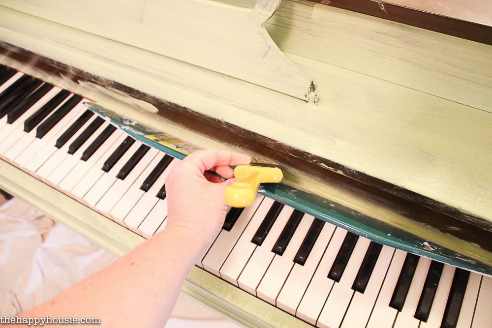 Painting the piano right up to the keys.