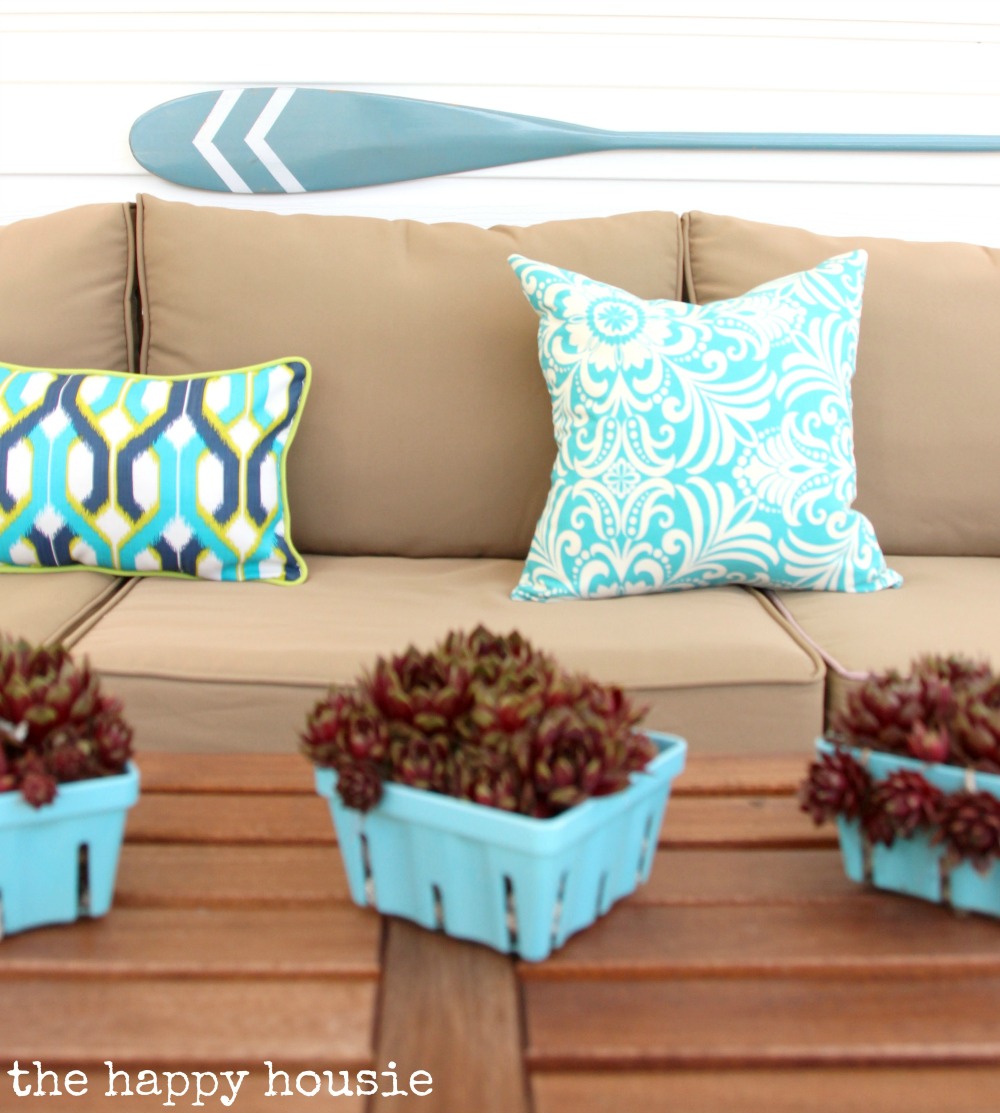 Blue pillows on the outdoor couch.