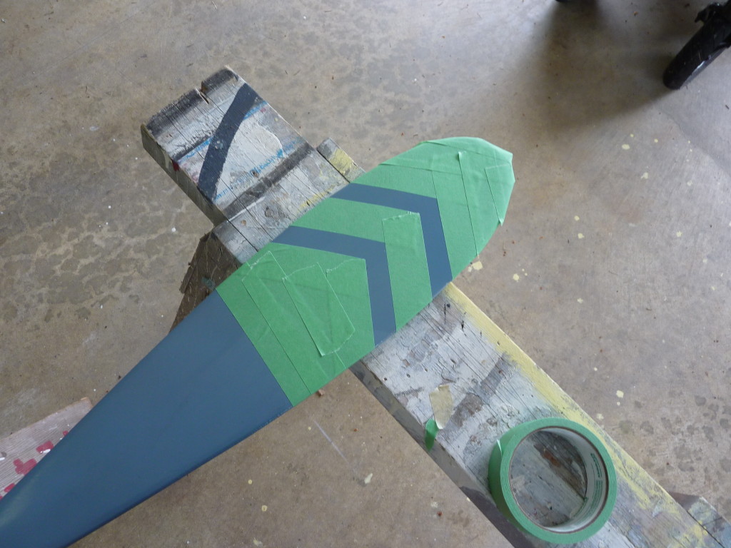 Taping the oar in frog tape for the arrow pattern.
