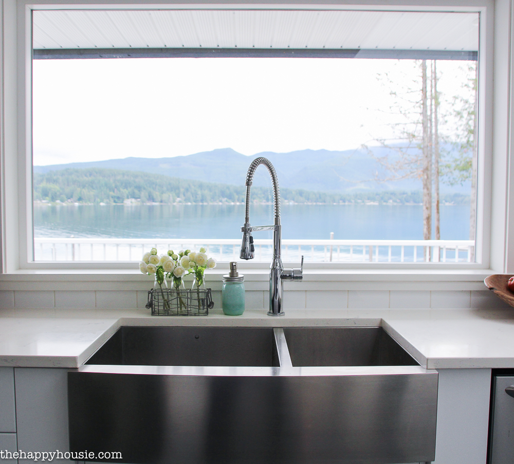 There is a view of the lake from the kitchen sink.