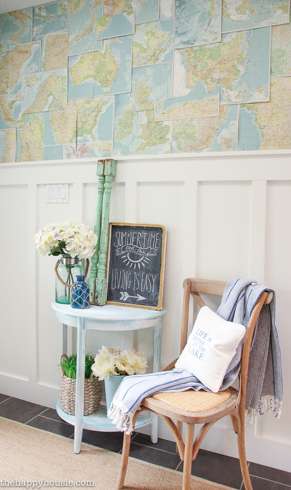 A wall is covered with a faux map in the hallway.