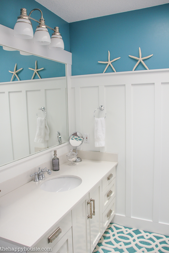 There are starfish on the wall in the bathroom.