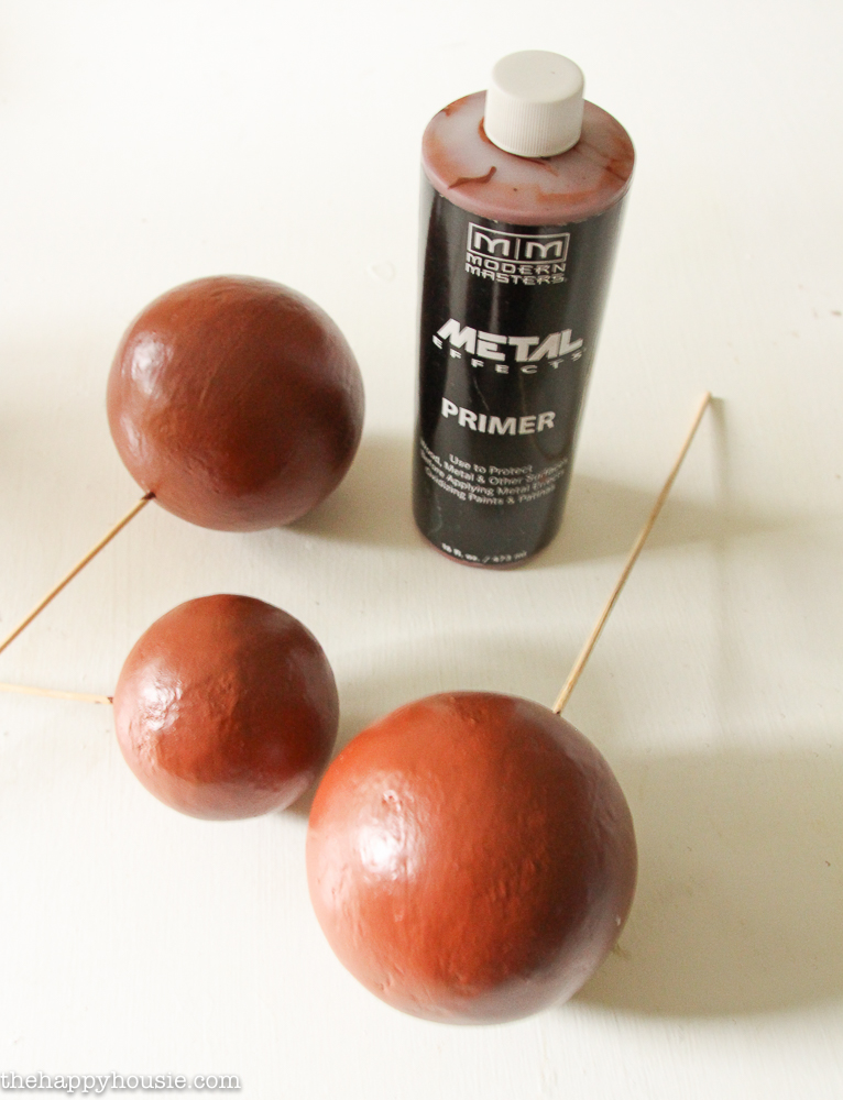 Applying copper primer to the balls.