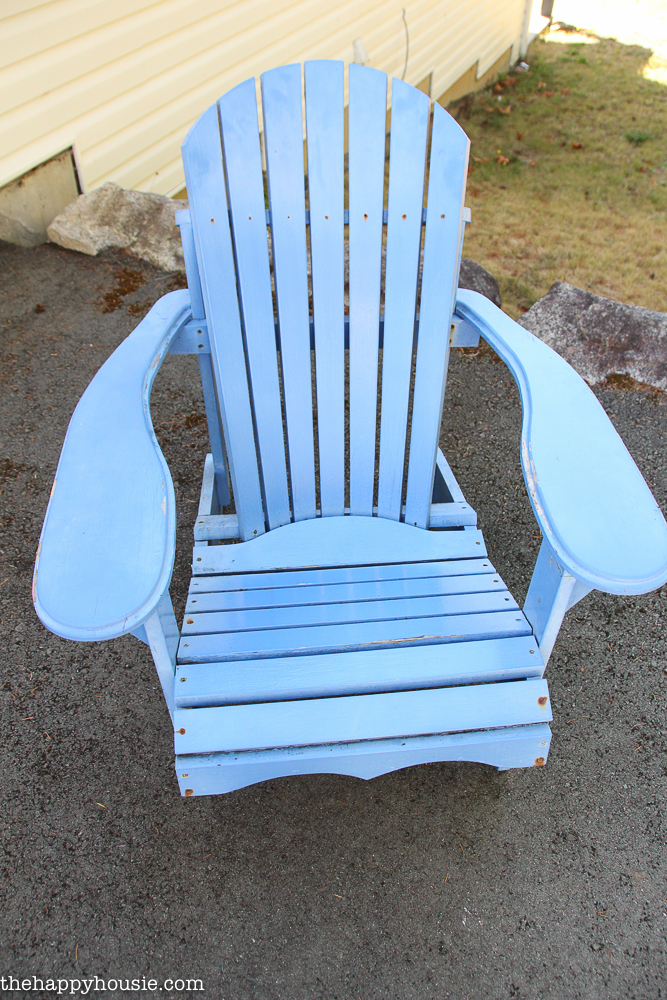 A large light blue outdoor chair on the patio.