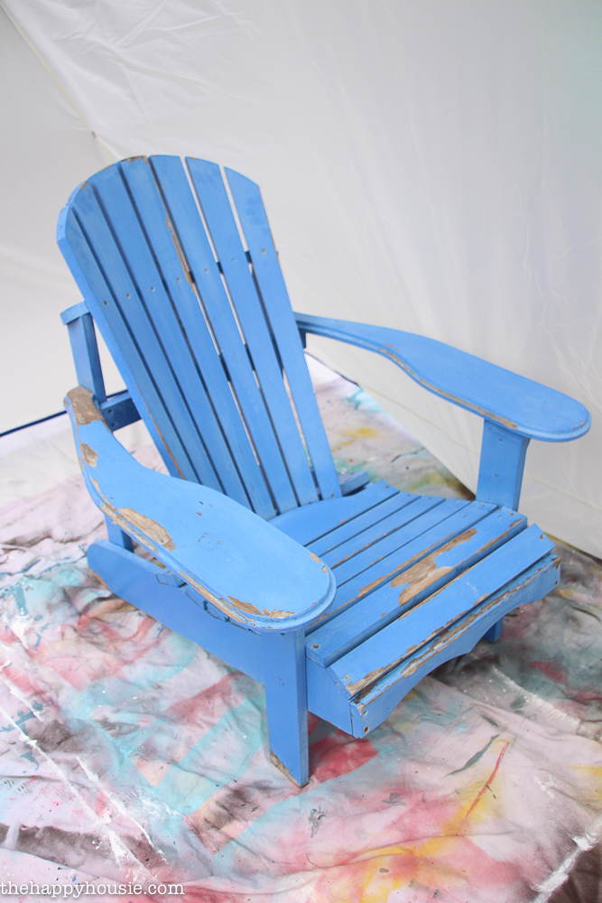 The blue chair in the spray shelter on a drop sheet.
