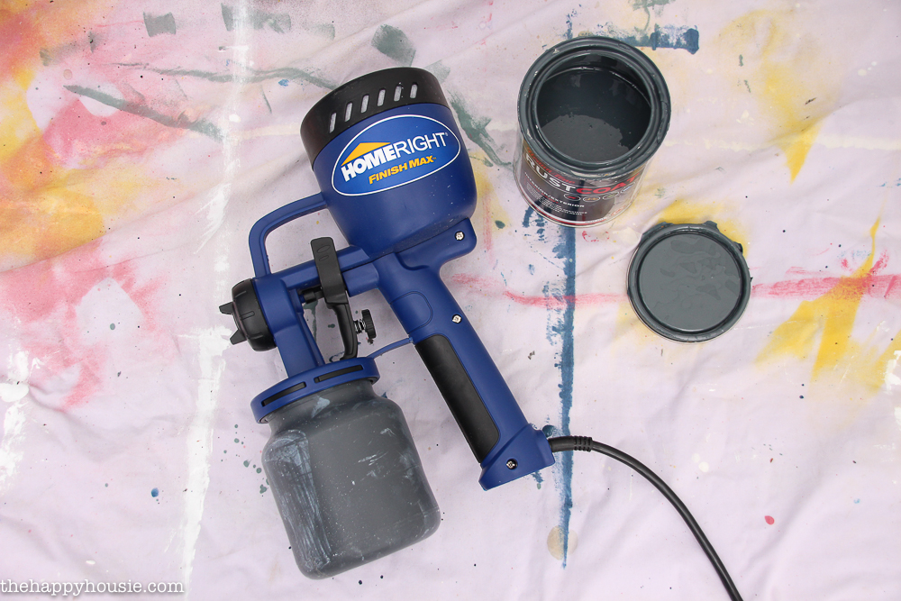 Preparing the Finish Max spray painter with paint.