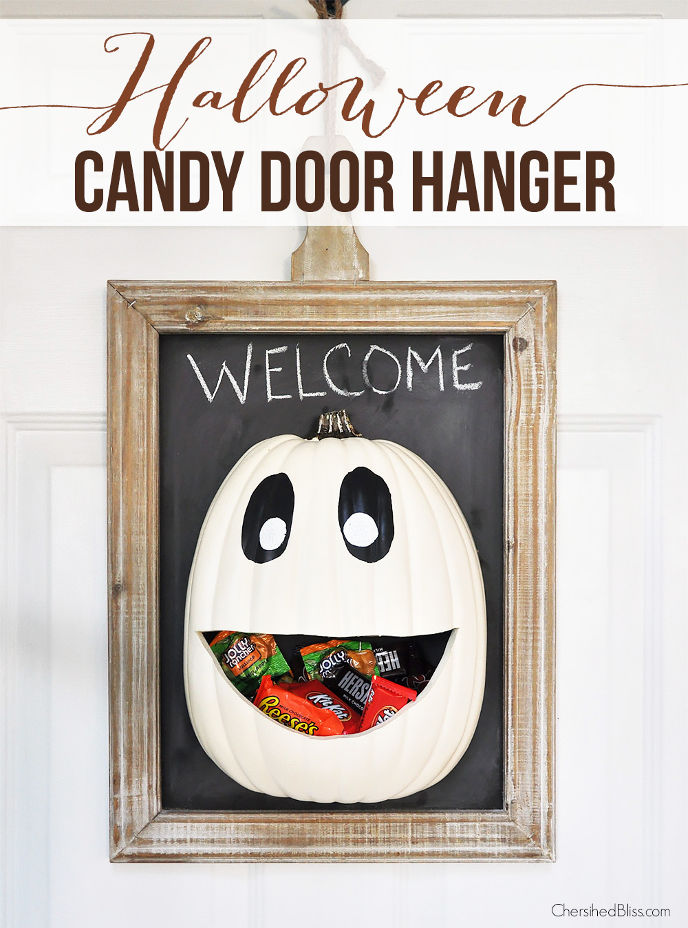 A door hanger with candy inside the pumpkin mouth.