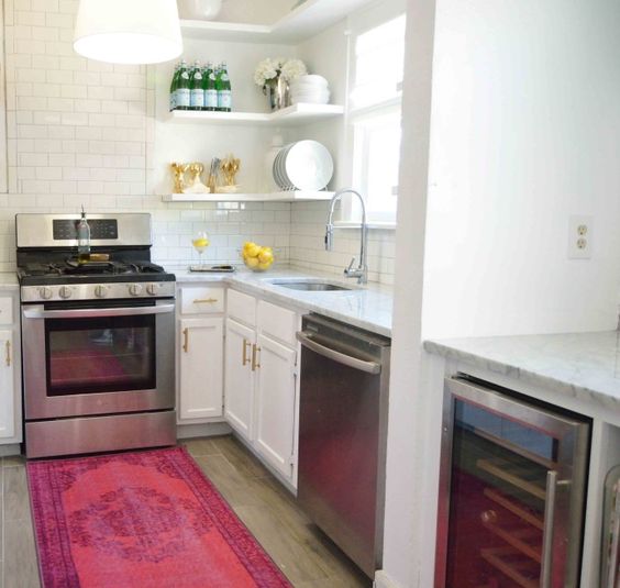 A pink/rose runner in a white kitchen.