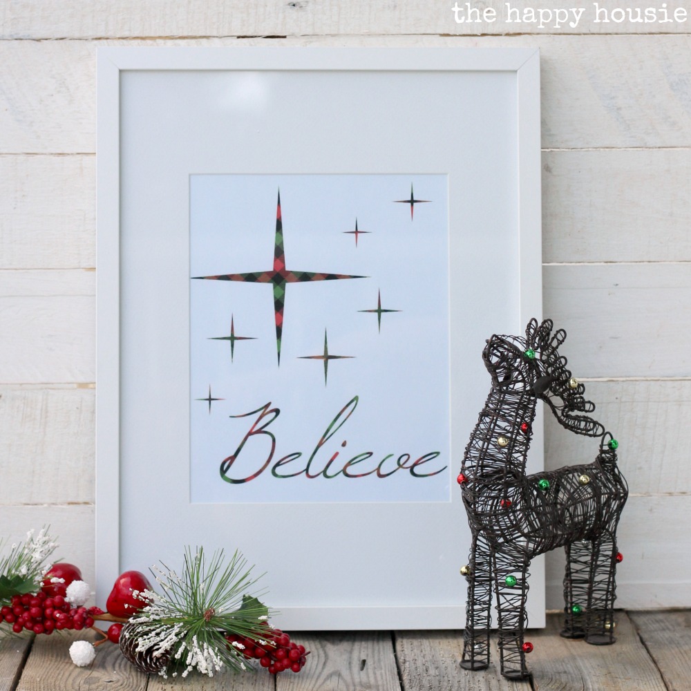 A Believe printable framed on the mantel.