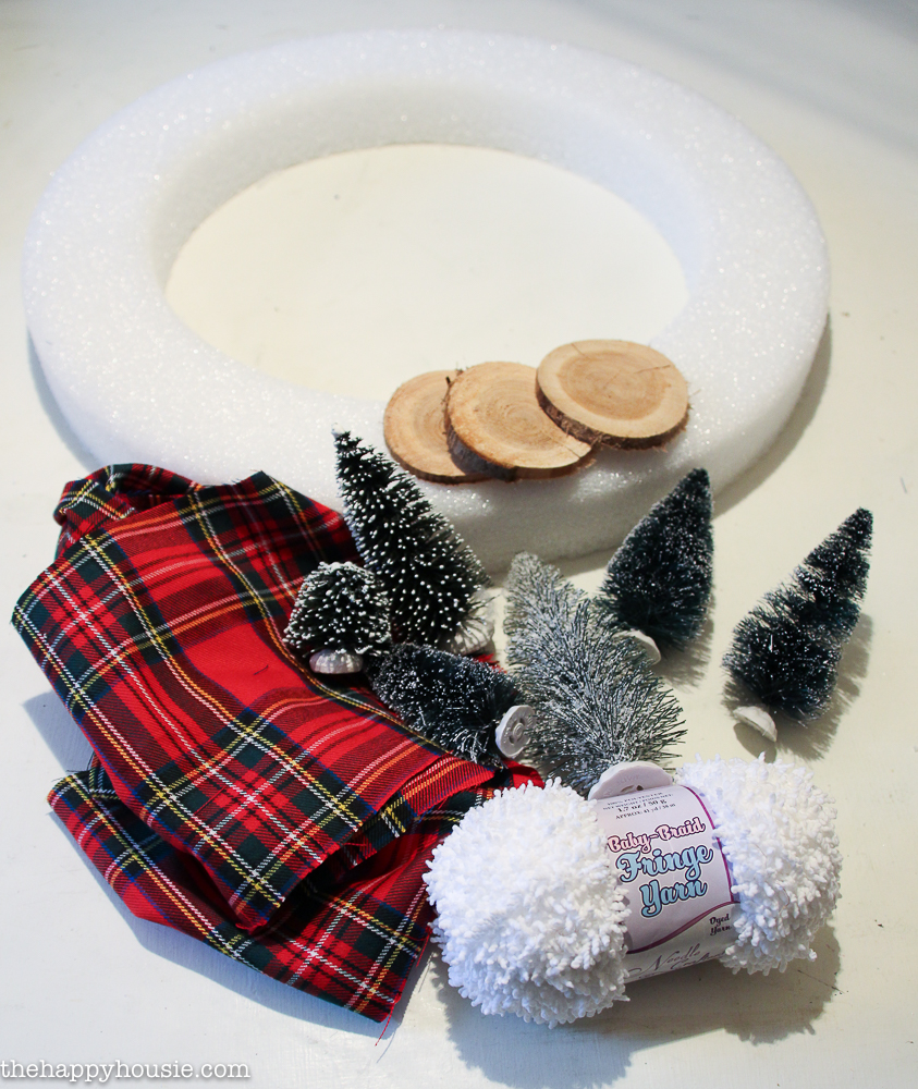 The white styrofoam plaid and bottle brust trees for making the wreath.