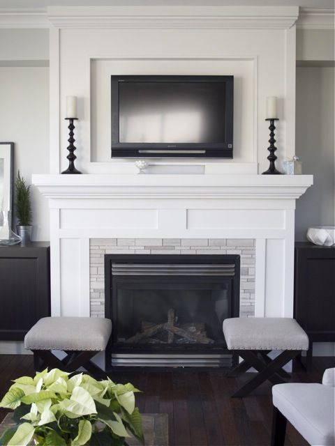 A white fireplace stone and mantel.