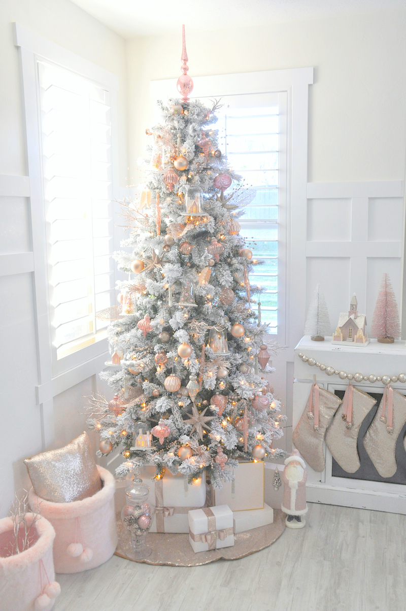 Soft blush pink decorations on a flocked tree.