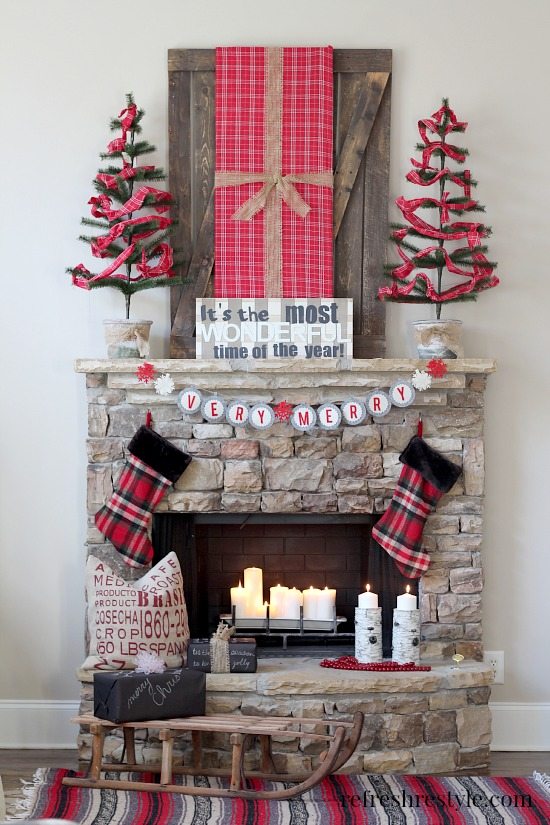 A Christmas holiday mantel with plaid stockings hanging up.