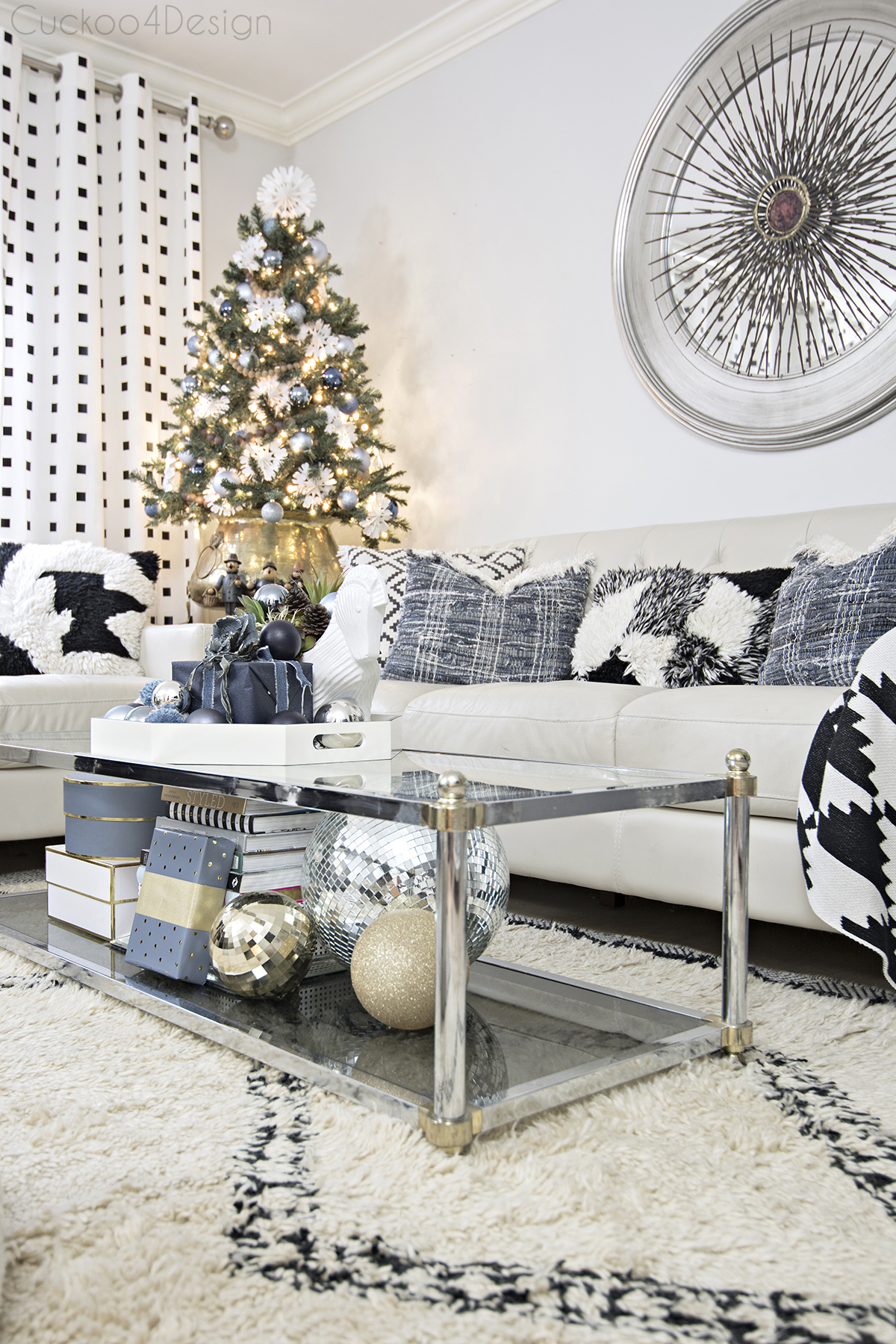 A neutral living room with a small Christmas tree in the corner.