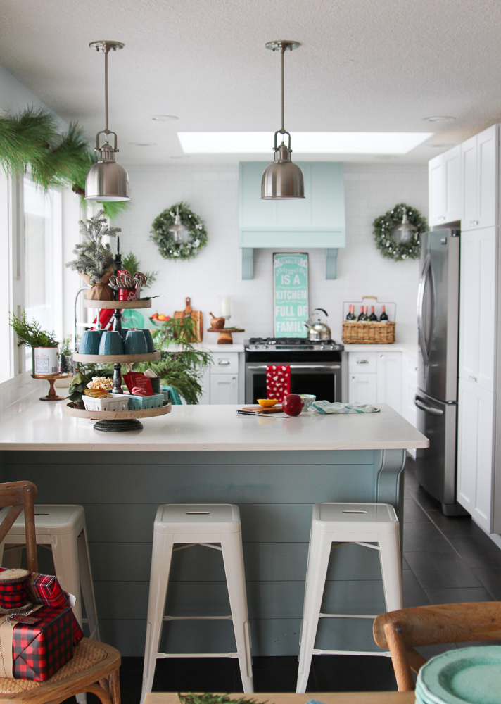 A light blue kitchen with pops of greenery for Christmas.