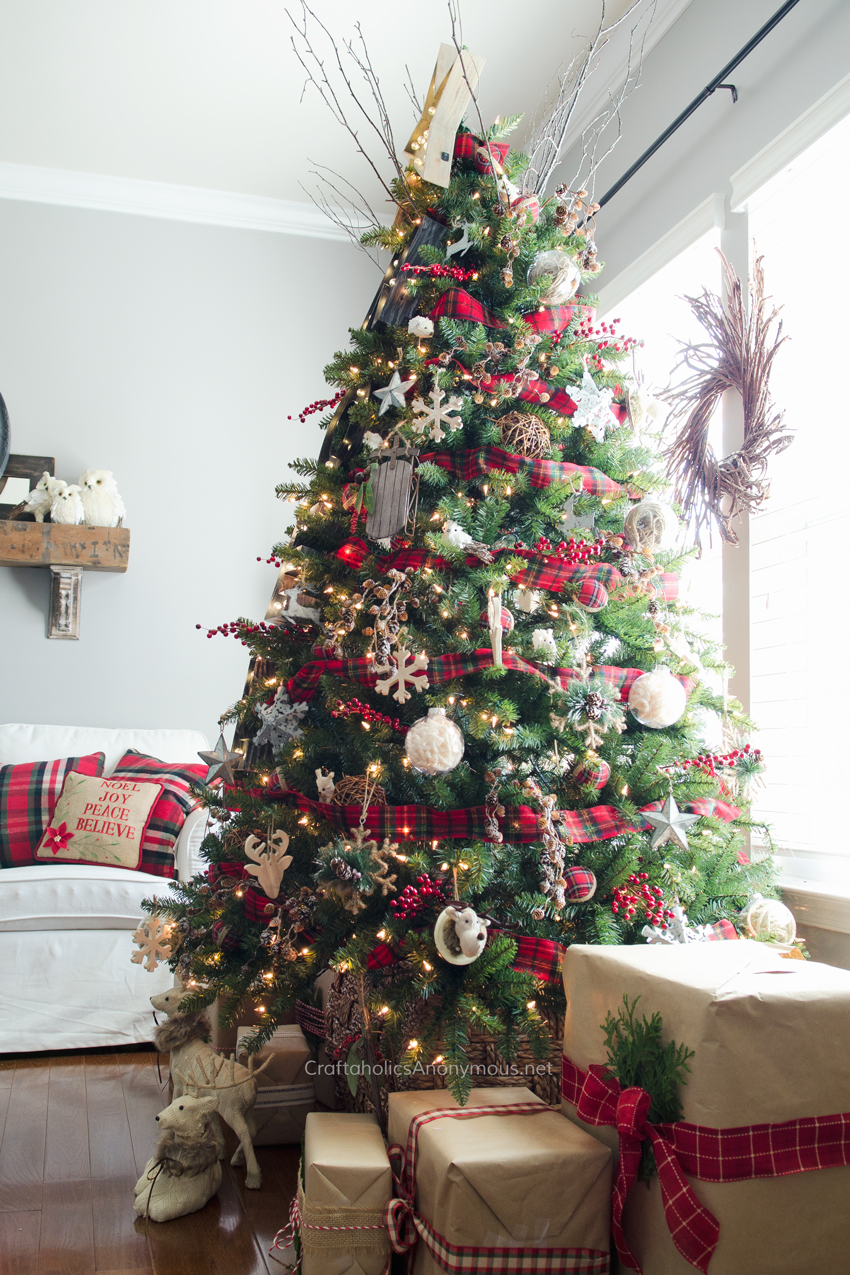 A large decorated Christmas tree in the living room.