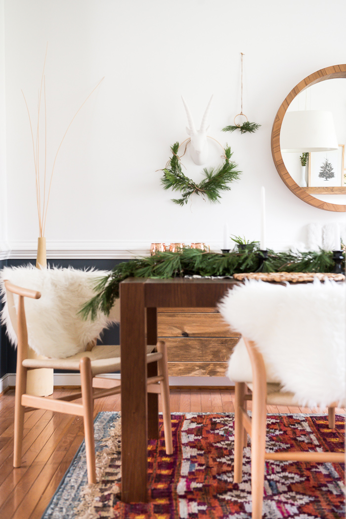 White faux fur on wooden chairs in the dining room.