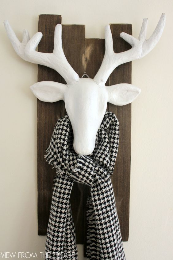 White antlers with a black and white scarf around it.