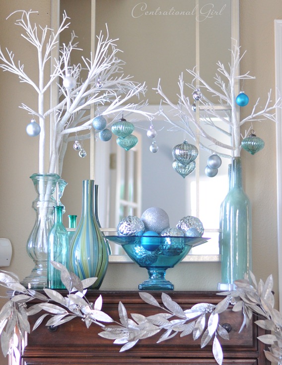 Glass light blue bowl filled with ornaments.