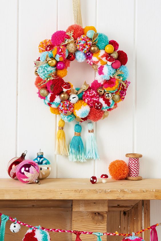 A brightly coloured pom pom wreath.