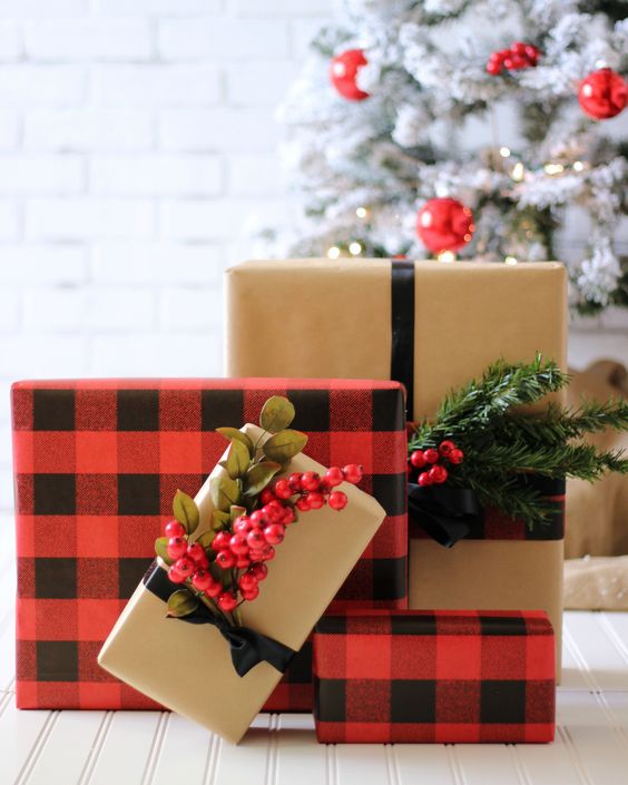 Wrapped Christmas presents with berries on it.