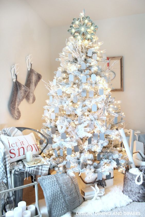 A large White Christmas tree in the corner of the room.