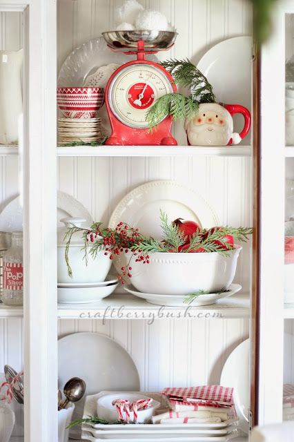 Dining room hutch with a Santa mug and pops of red.