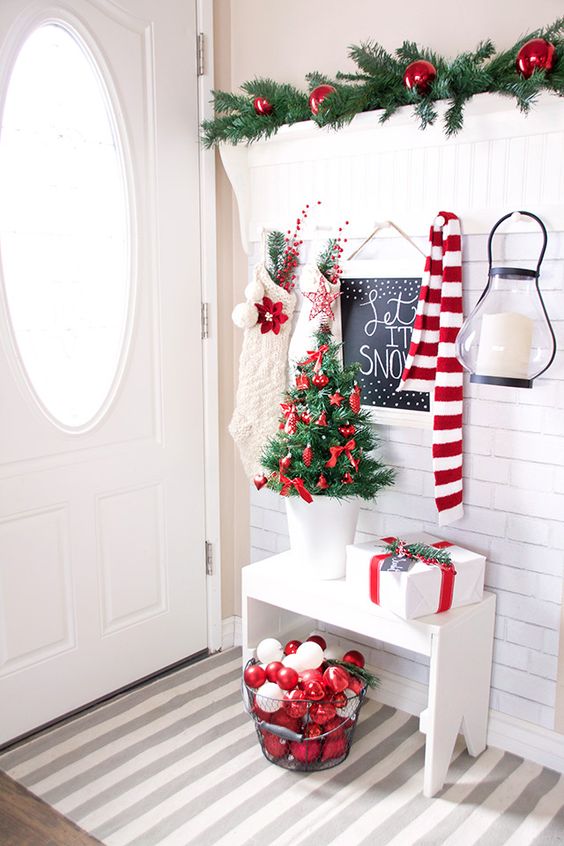 A white entryway with pops of red.