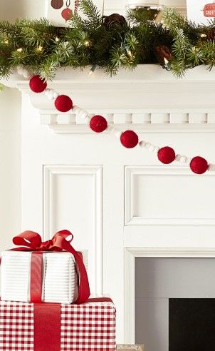 Garland with red balls strung along the mantel.