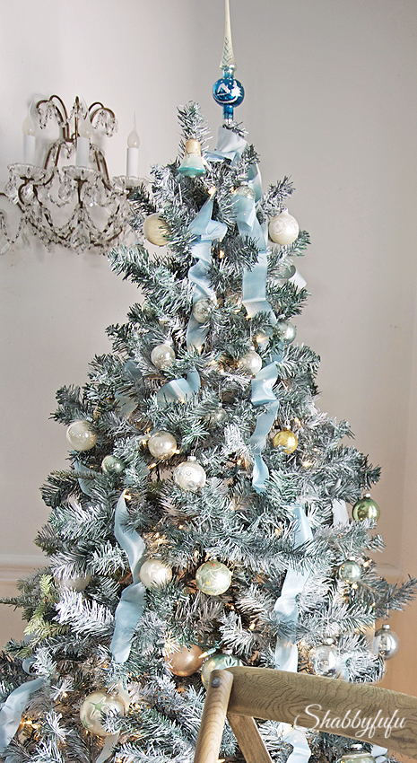 A decorated light blue Christmas tree.
