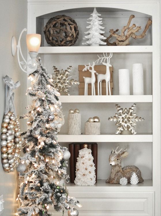 White shelves with Christmas ornaments on them such as deer and trees all in white.