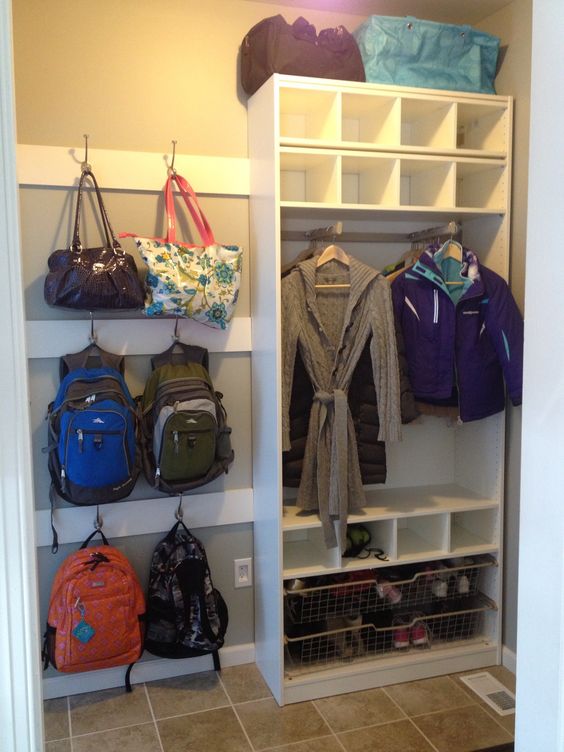 Bags and knapsacks hung on hooks by the front door.
