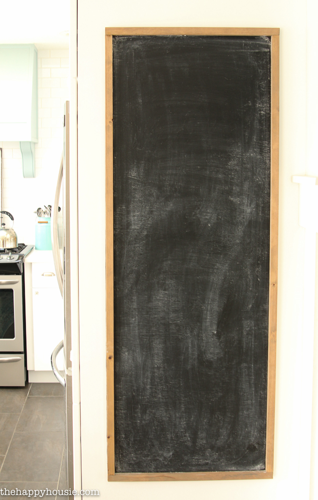 The blank chalkboard on the wall.