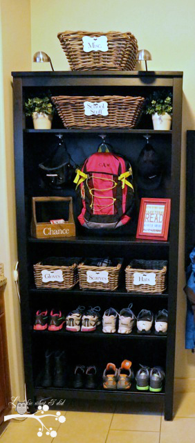 A shelving unit filled with shoes and a backpack.