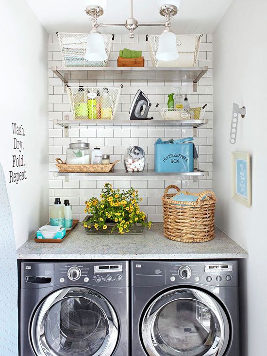 A modern washer and dryer with a small shelving unite above it.