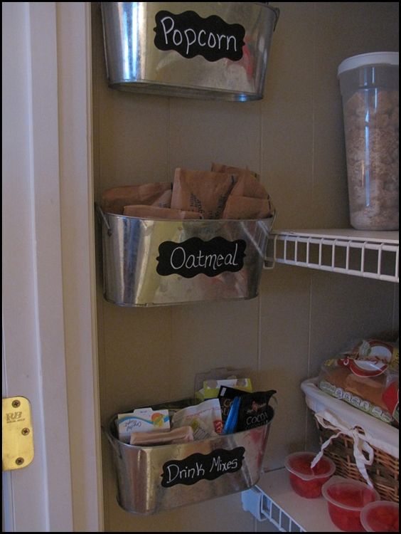 Hanging containers full of popcorn, oatmeal and drink mixes.