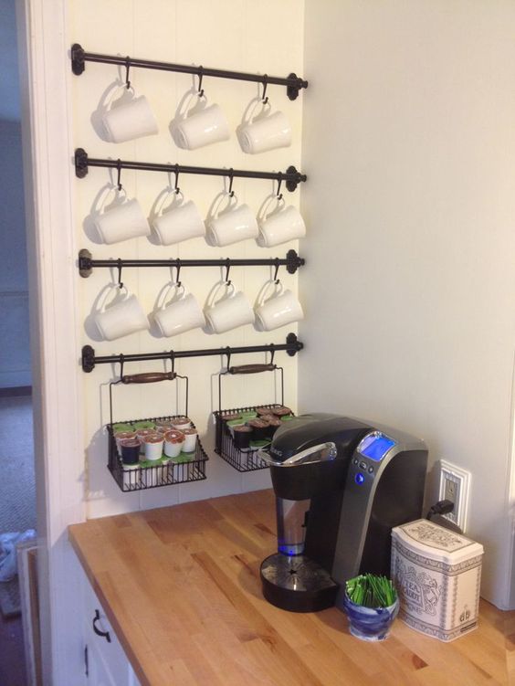 Using curtain hangers to hang your coffee cups.
