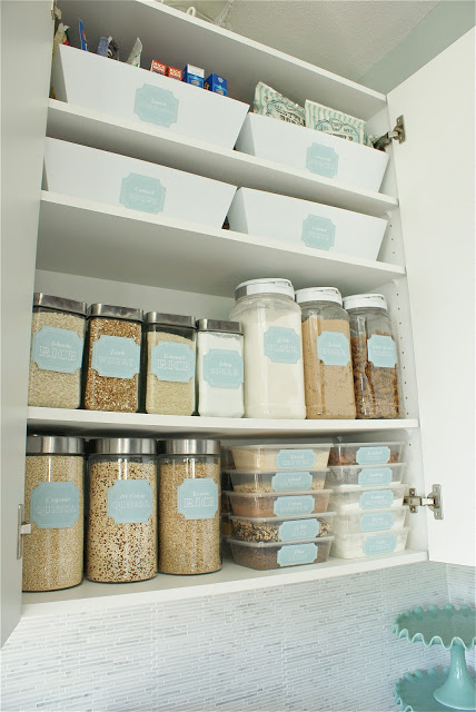 Flour, and grains inside glass jars on the shelf.