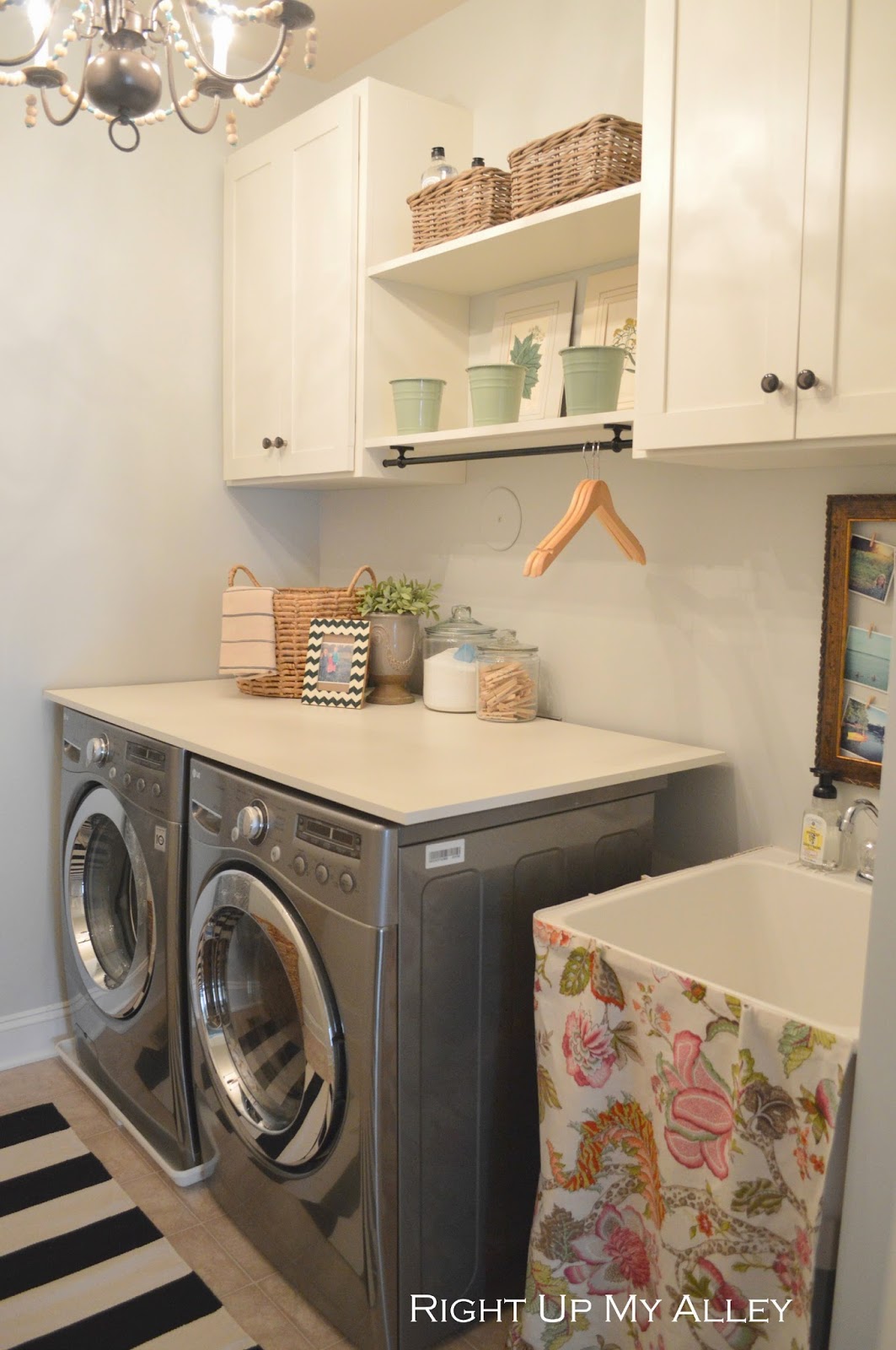 White cabinets flank the washer and dryer.